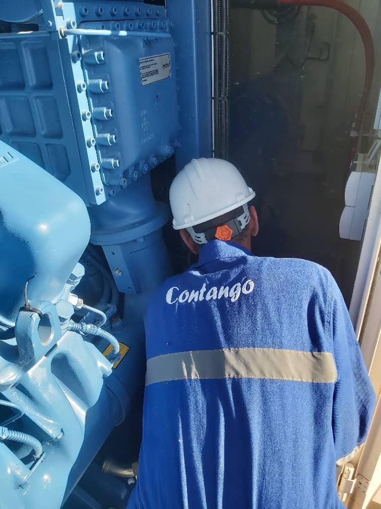 Contango technician servicing a gas engine